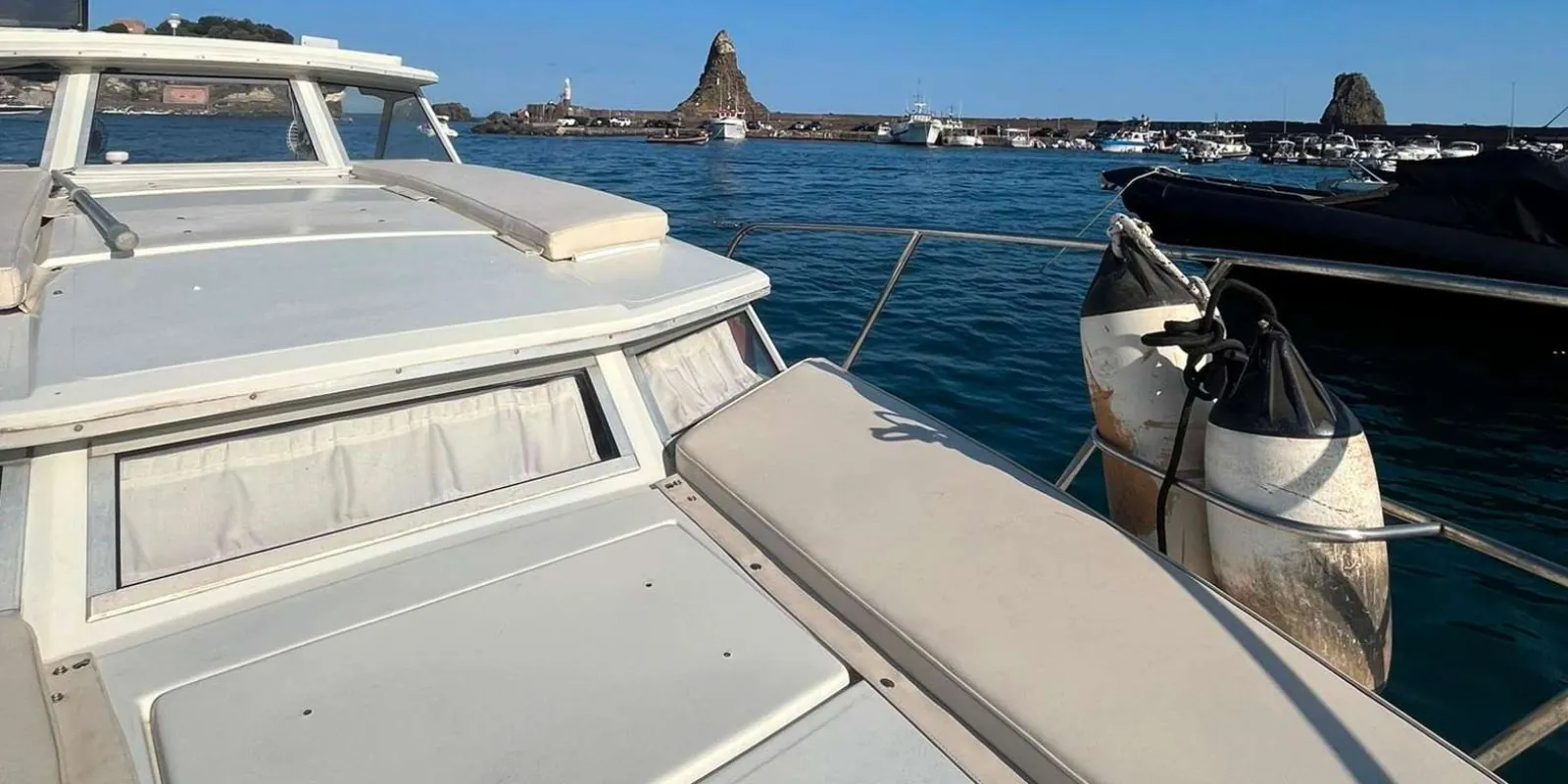Mount Etna visible in the distance during the boat excursion to Acitrezza