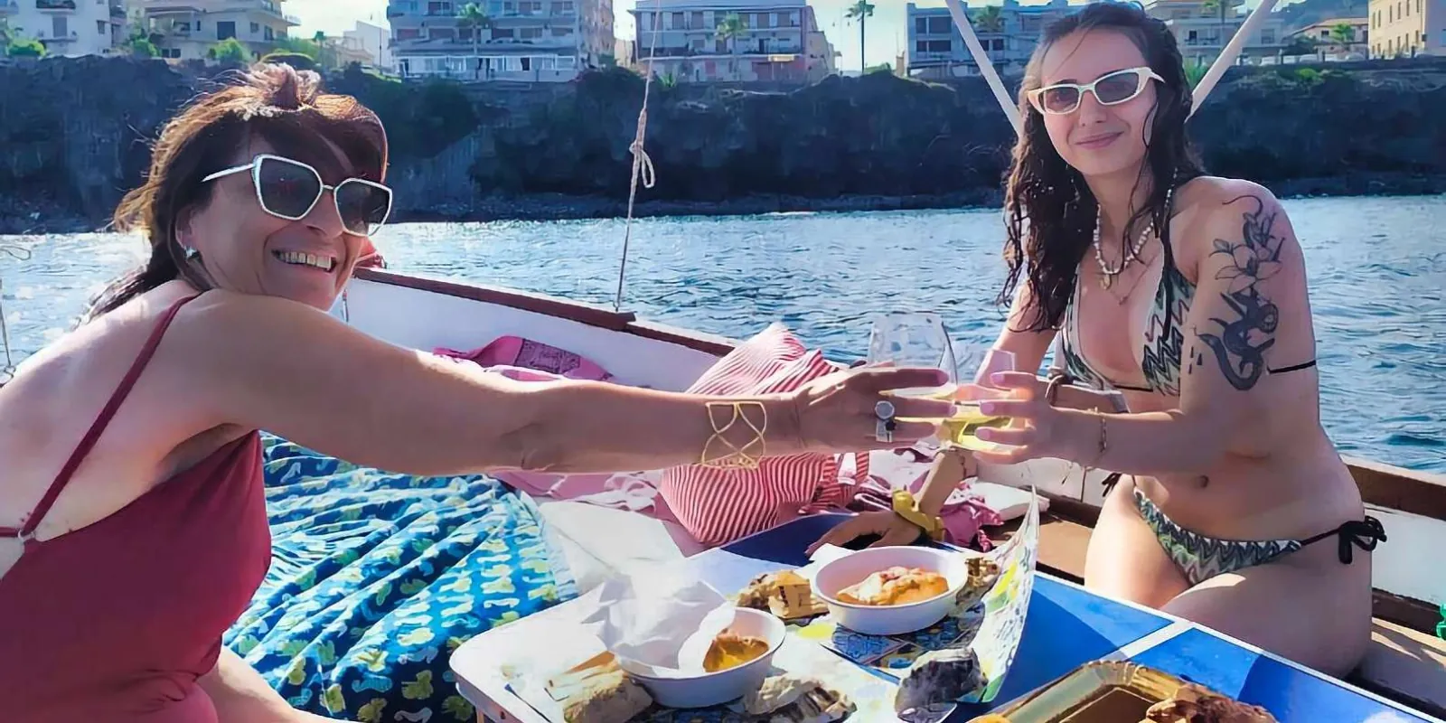 Private boat tour guests relaxing on deck during the Sicilian lunch stop